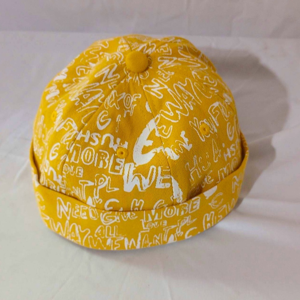 Vintage yellow brimless hat with rolled cuff and adjustable strap